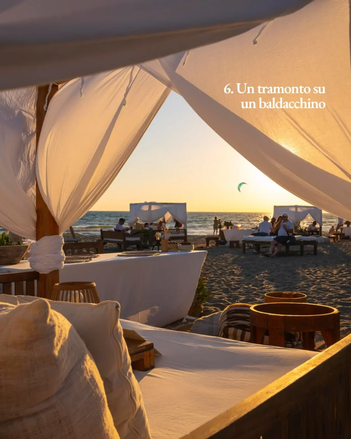 Singita Miracle Beach: Relax under a cabana on the sandy beach at sunset in the city.