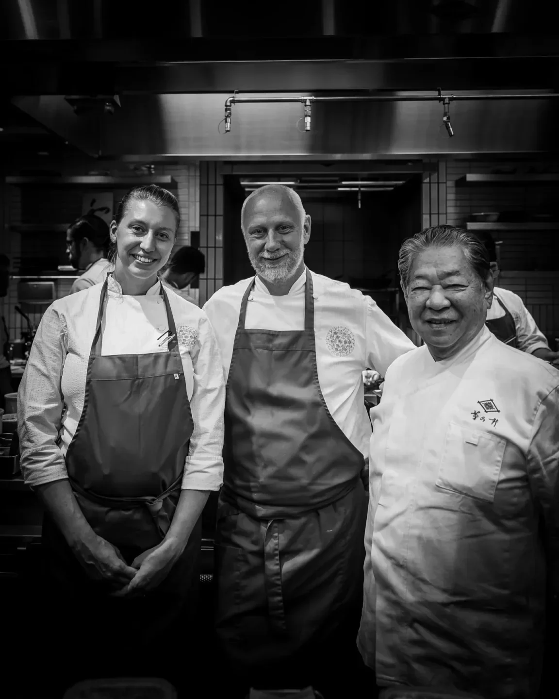 Chefs posing at SingleThread Farms Restaurant in Healdsburg, California, in a professional kitchen.