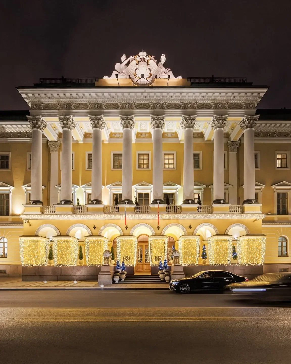 Exterior view of Sintoho restaurant in St Petersburg, illuminated at night with lights.