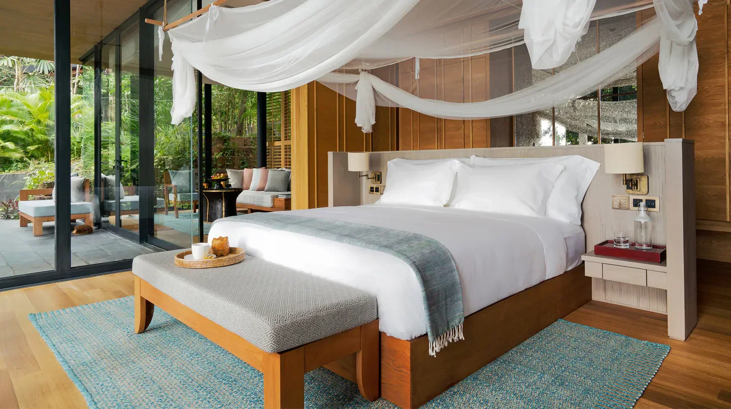 Bedroom interior at Six Senses Krabey Island in Siem Reap, with outdoor views.