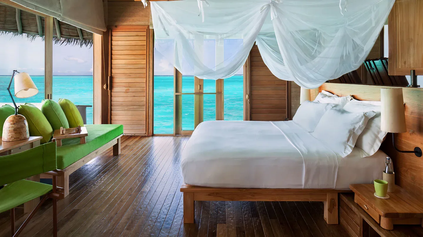 Bedroom at Six Senses Laamu in the Maldives with ocean view and canopy bed