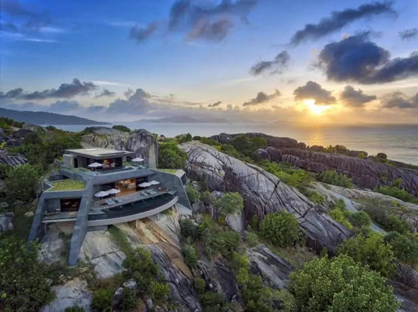 Spectacular view of Six Senses Spa Zil Pasyon in The Bahamas, perched on a cliffside with sunset