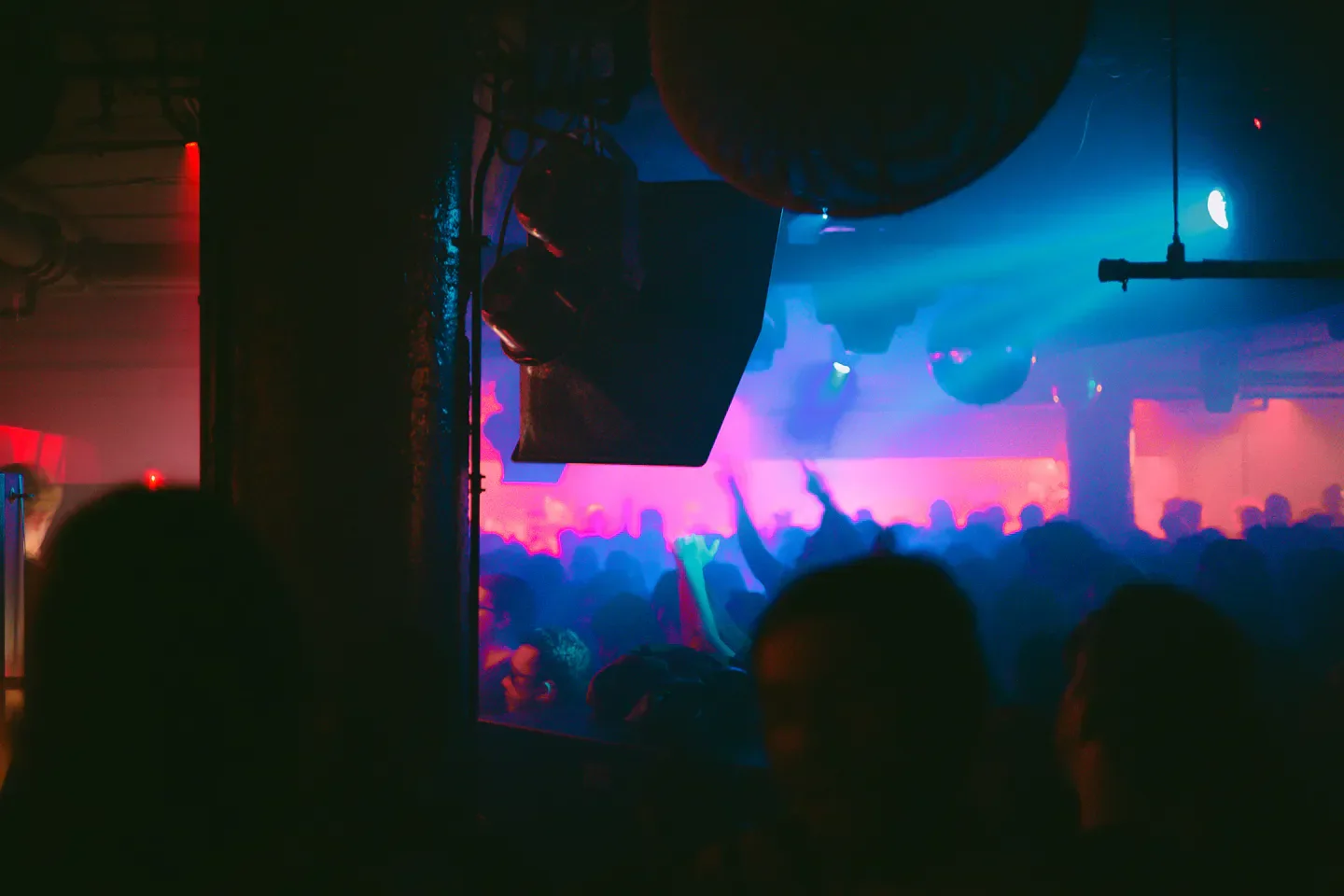 Energetic crowd at Smart Bar nightclub in Chicago, illuminated by vibrant neon lights.