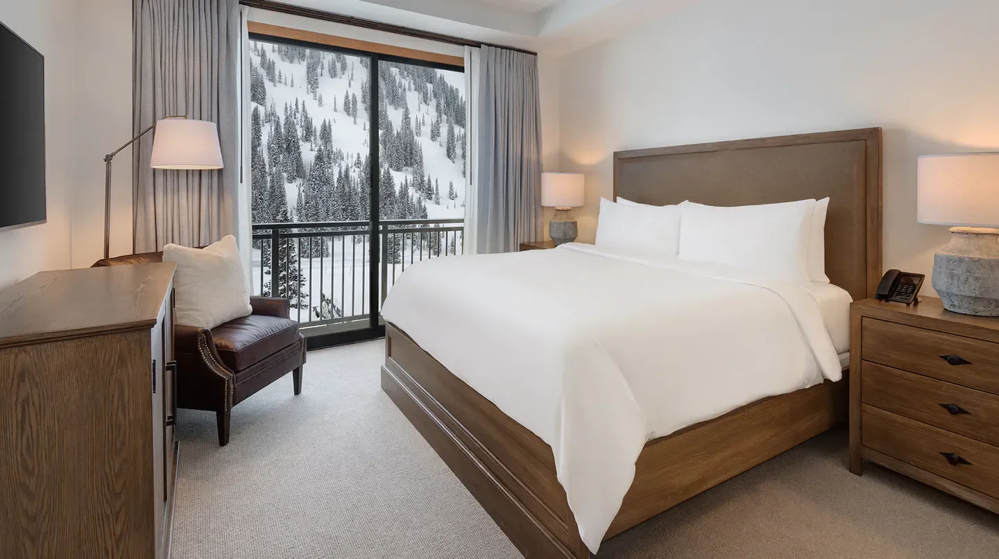 Cozy bedroom at Snowpine Lodge in Salt Lake City with mountain views.