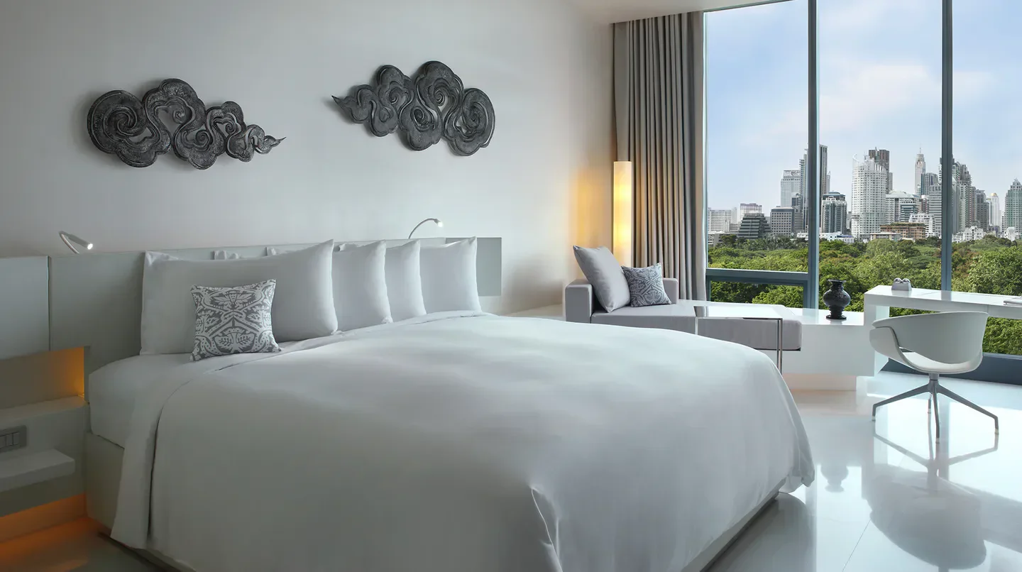 Modern SO/ Bangkok hotel room with city views overlooking the vibrant Bangkok skyline.