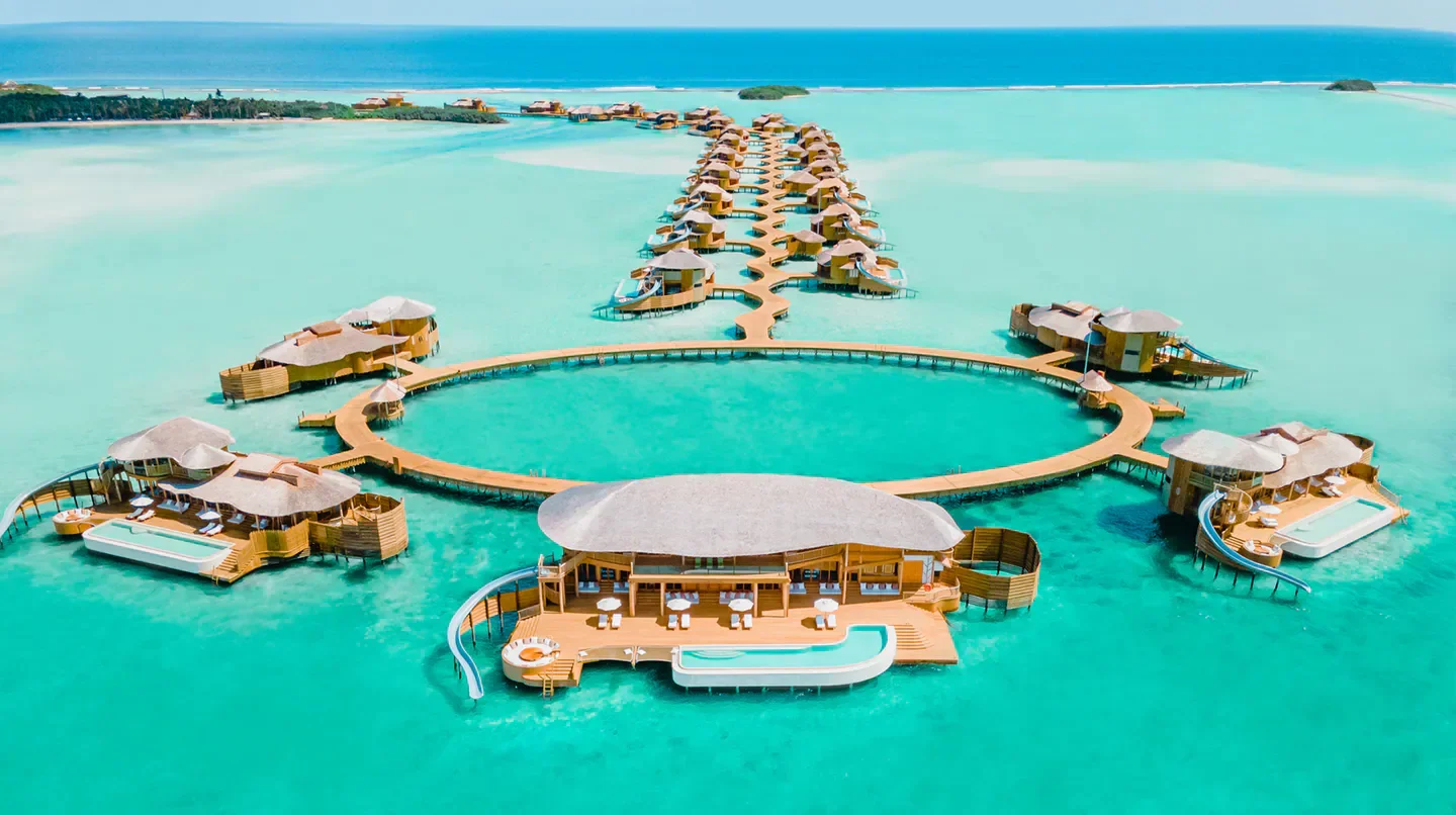 Aerial view of luxury overwater villas at Soneva Jani resort in the Maldives.