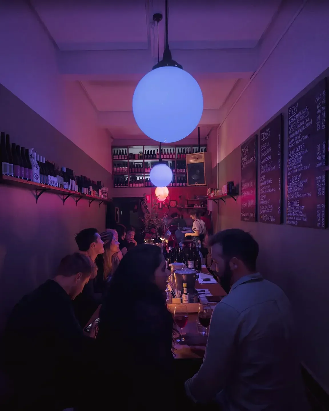 Interior of Sonny restaurant in Hobart, with glowing lights and customers at the bar.