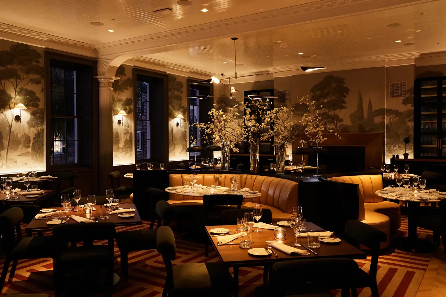 Cozy dining room at Sorelle restaurant in Charleston, featuring elegant decor and lighting.