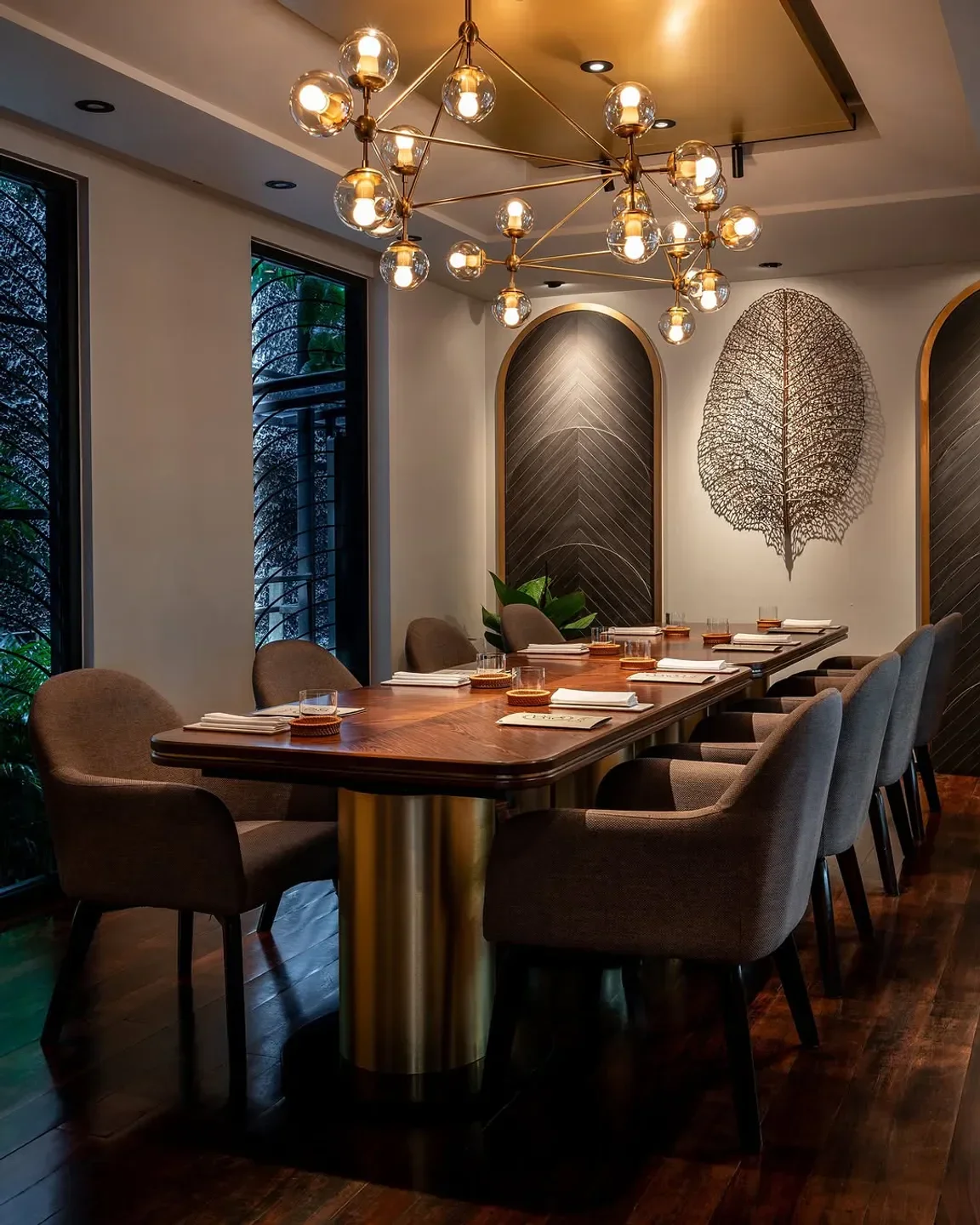 Elegant dining room at Sorn restaurant in Bangkok, featuring stylish lighting and decor.