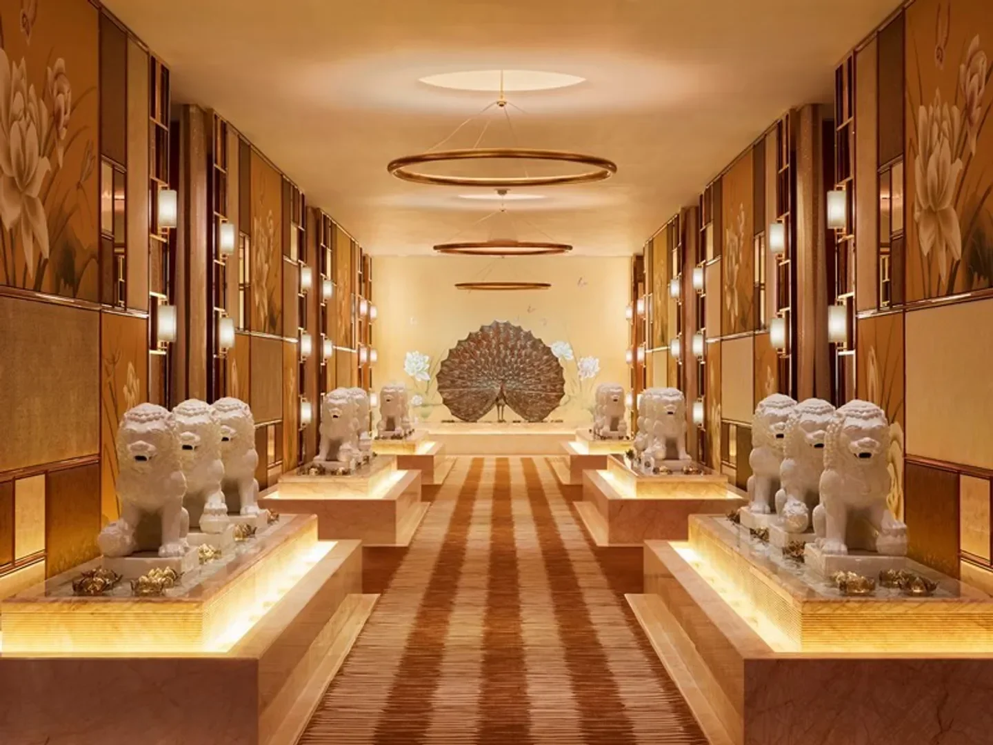 Elegant corridor at Spa at Wynn Palace Macau, with lion statues and ornate decor.