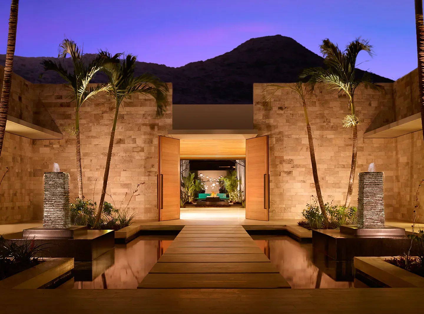 Entrance to Spa Montage Los Cabos in Cabo San Lucas, with fountain and palms.