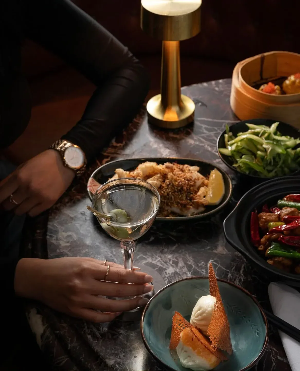 Spice Temple Melbourne: Table set with cocktails and Asian cuisine, fine dining experience.