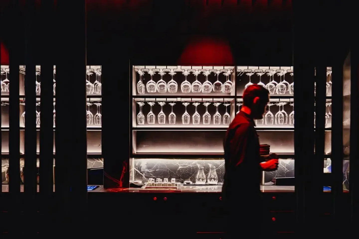 Interior of Spice Temple in Sydney with a sleek bar and hanging wine glasses