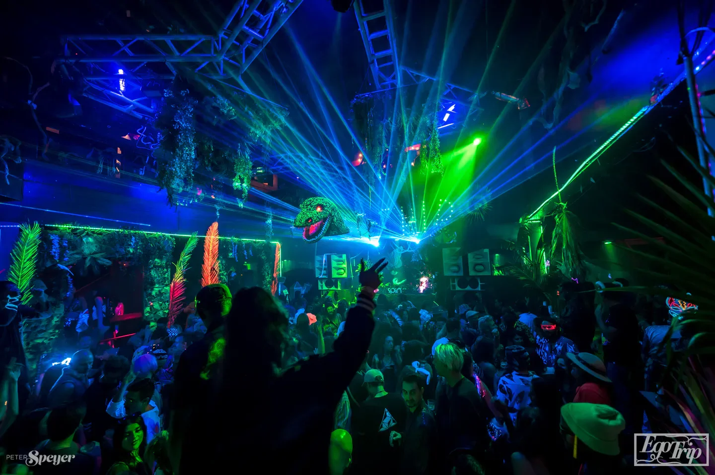 Energetic dance floor at Spin San Diego nightclub with laser lights and lively crowd.