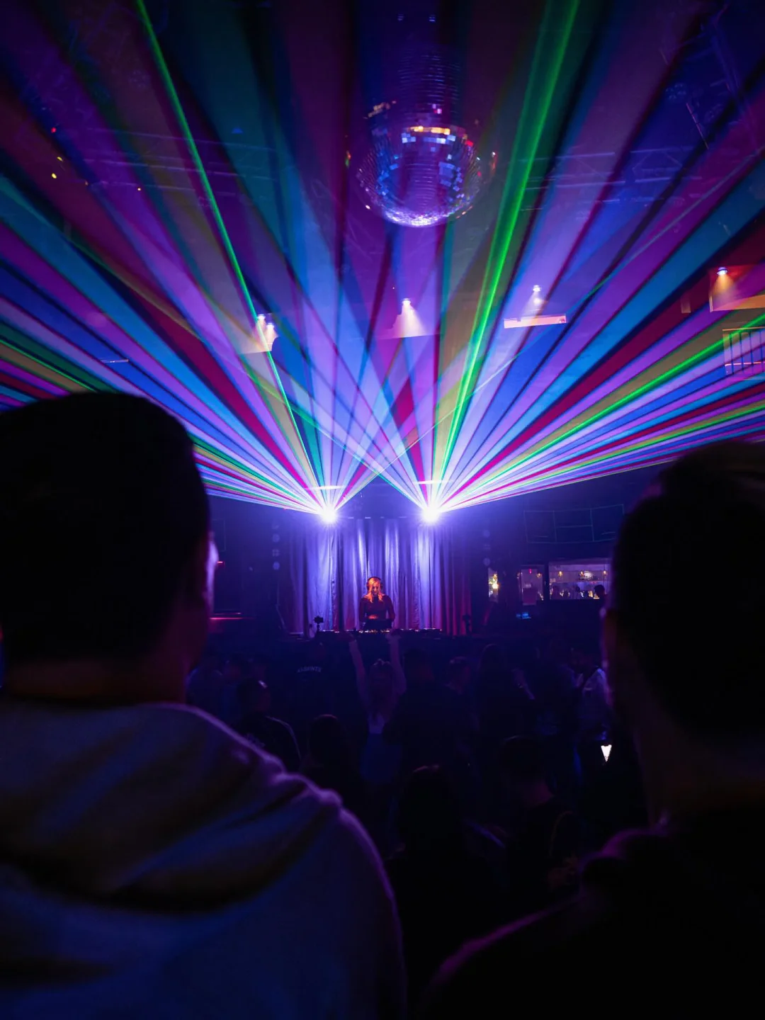 Colorful laser lights illuminate the dance floor at Spin nightclub in San Diego, creating a vibrant ambiance for a night out.