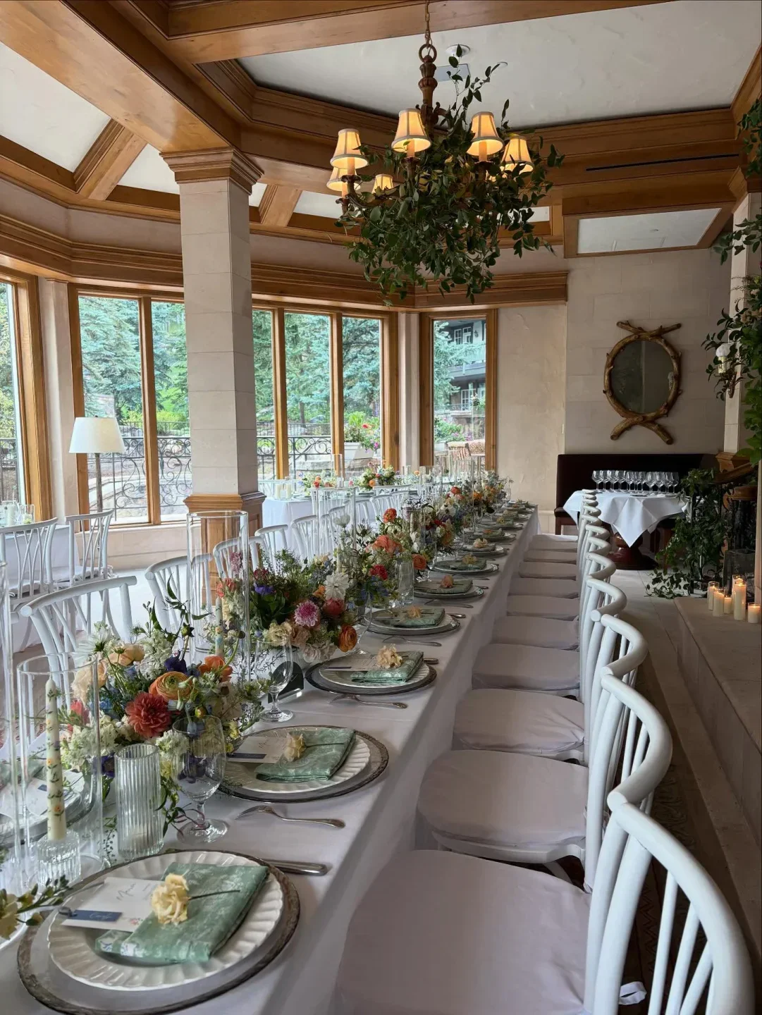 Elegant dining at Splendido at The Chateau in Vail, featuring floral arrangements and stylish setting.