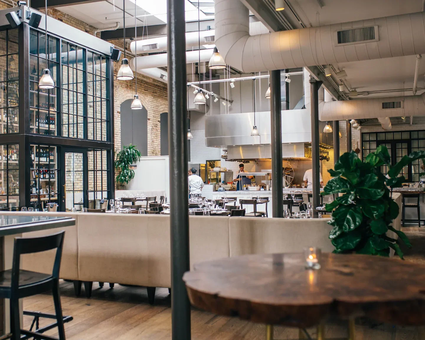 Interior of Spoon and Stable restaurant in Minneapolis, showing dining and kitchen areas.