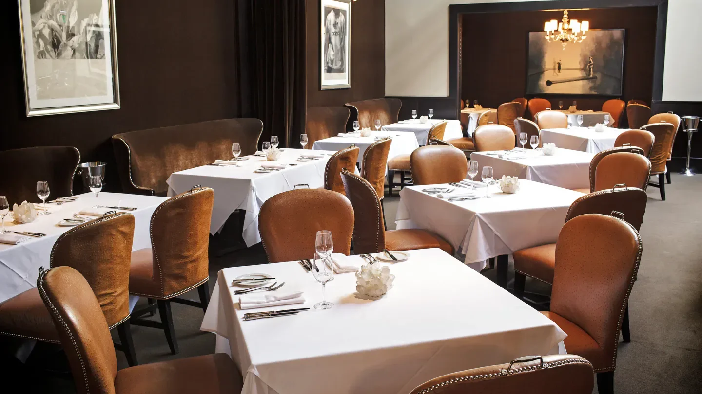 Elegant dining room interior at Spruce restaurant in San Francisco with tables set.