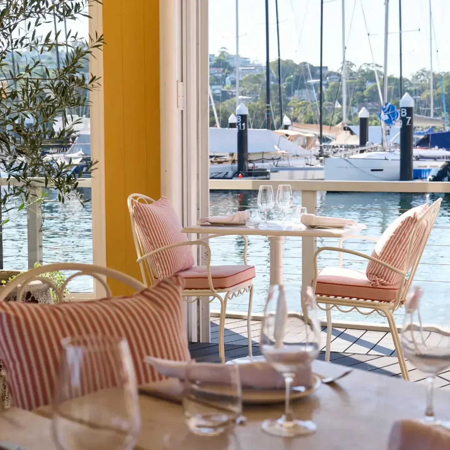Outdoor dining at St Siandra restaurant in Sydney, featuring harbor views and stylish decor.