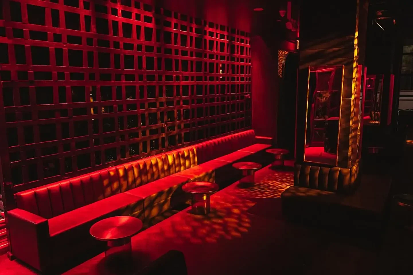 Interior of Stafford Room nightclub in New York City with red lighting and stylish decor.