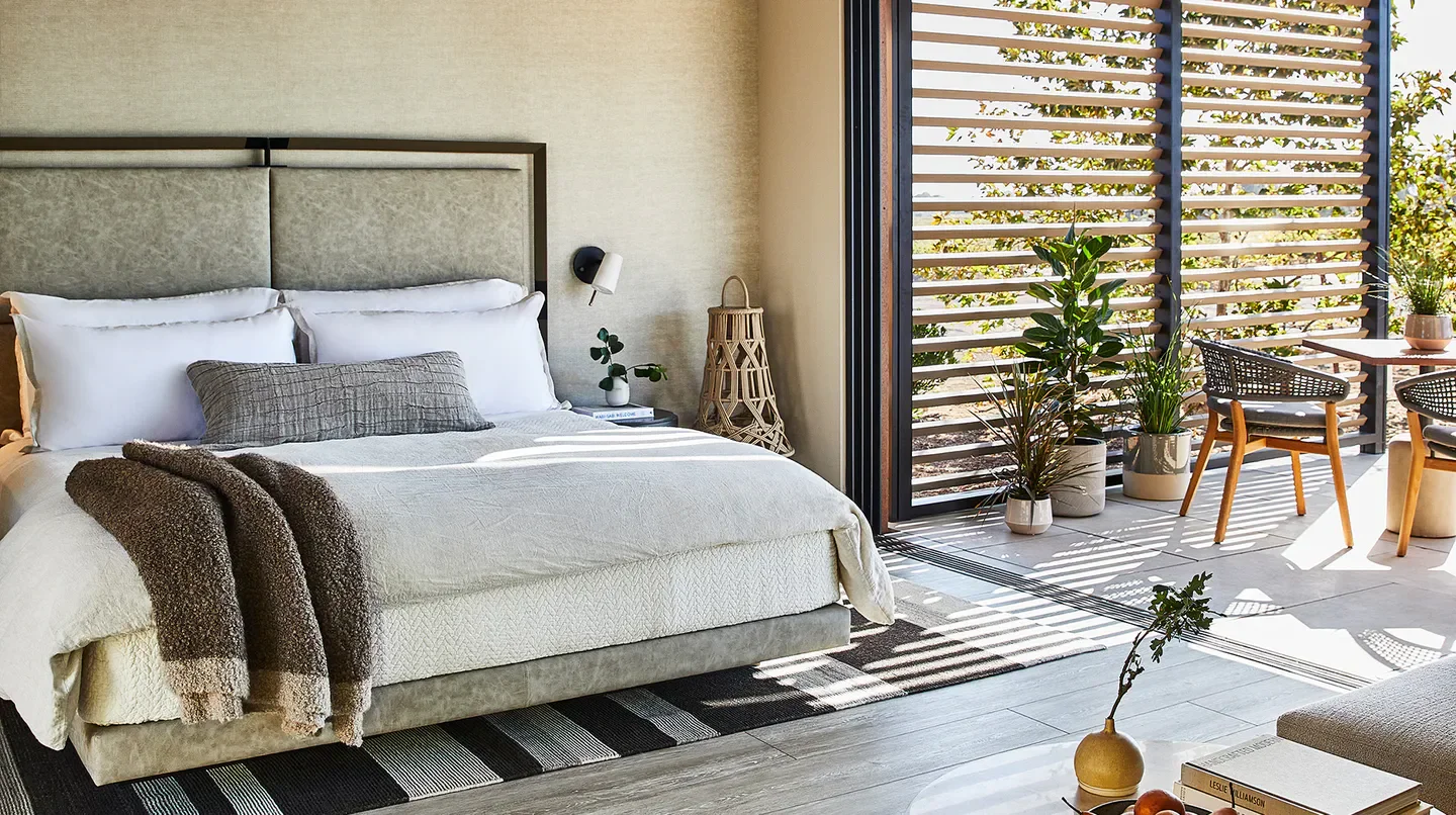Cozy bedroom at Stanly Ranch, Auberge Resorts Collection in Napa with patio access.