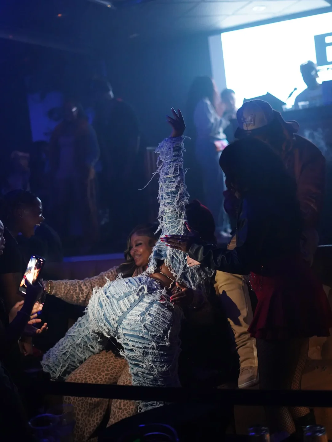 People enjoying nightlife at Stars and Spirits in Dallas, dancing with friends in a vibrant nightclub setting