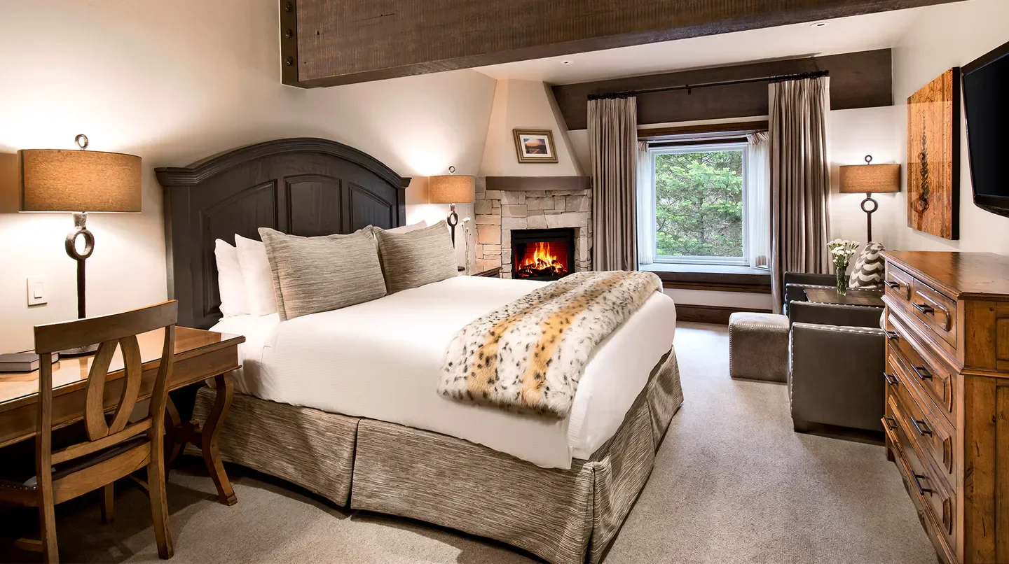 Cozy bedroom at Stein Eriksen Lodge Deer Valley, Park City, with fireplace and luxurious decor.