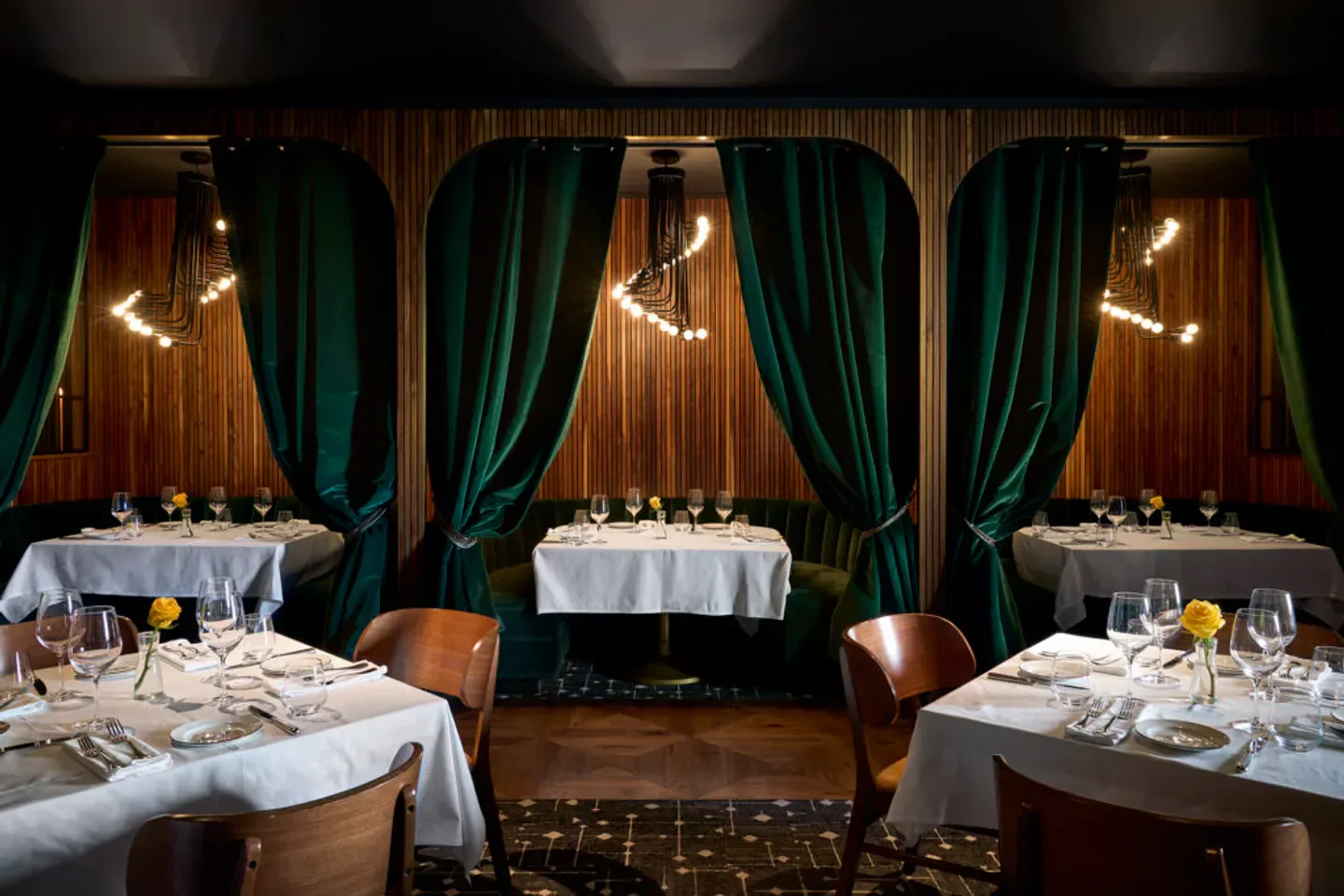 Cozy dining area at Stillwell's restaurant in Dallas, featuring elegant decor and tables set.