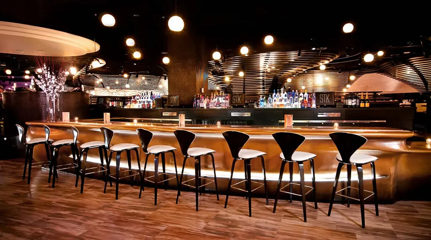 Elegant bar at STK Las Vegas with stylish seating and a well-stocked bar.