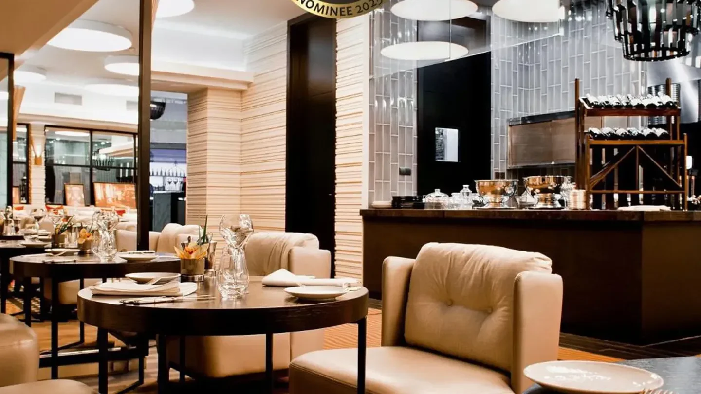 Elegant interior of Strefa restaurant in Warsaw, featuring tables and cozy seating.