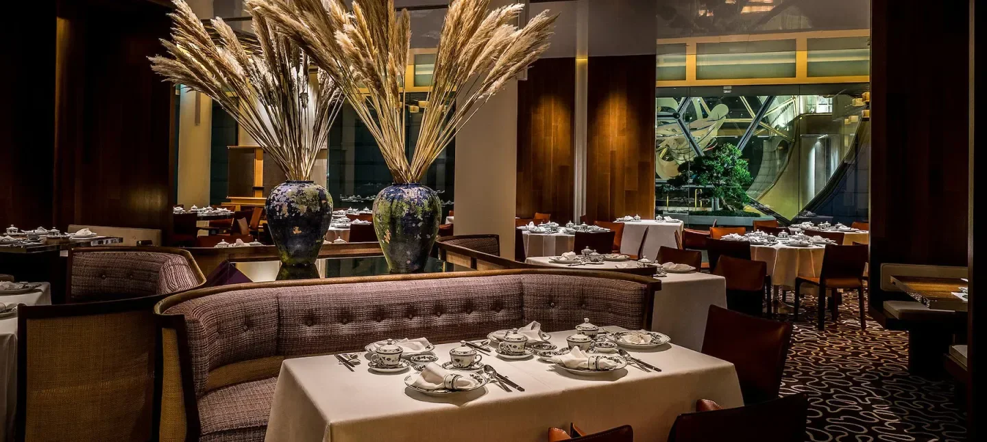 Elegant interior of Summer Pavilion restaurant in Singapore with decorated tables