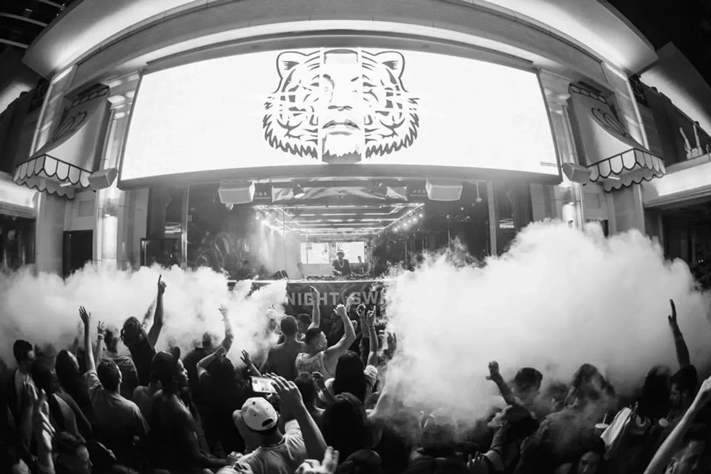 Energetic crowd at Surrender nightclub in Las Vegas with stage and smoke effects