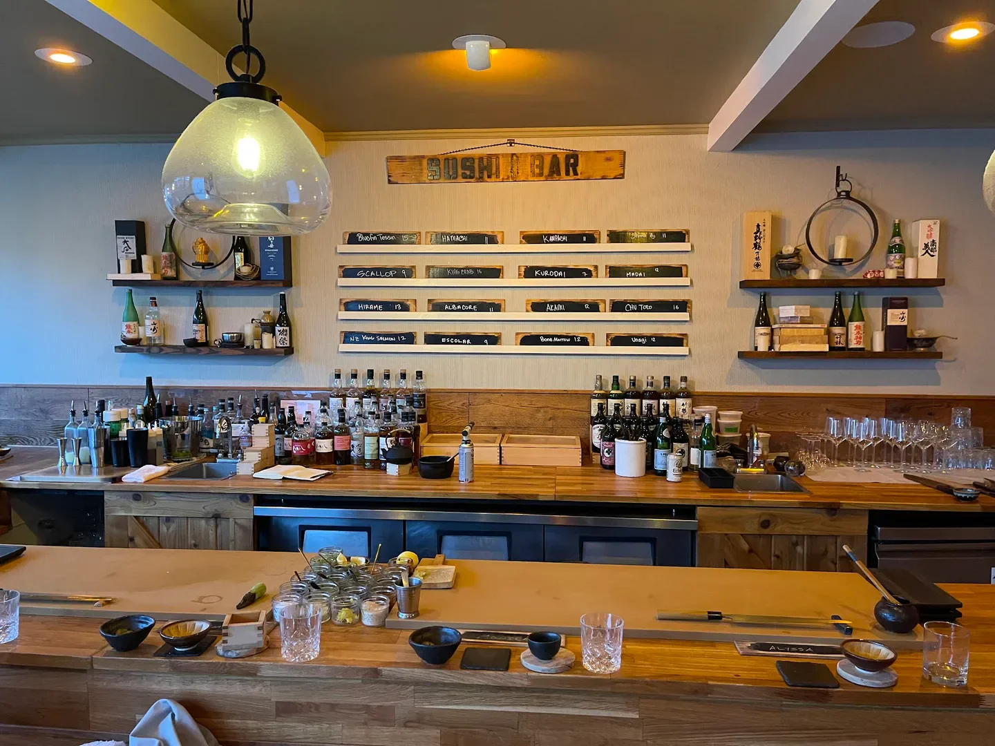Interior of Sushi by Scratch: Montecito in Santa Barbara, showcasing bar and menu.