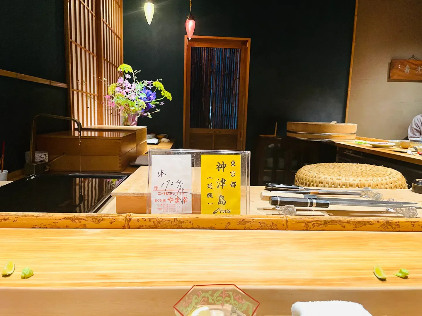 Interior view of Sushi Gyoten in Fukuoka, showing the sushi counter and restaurant details