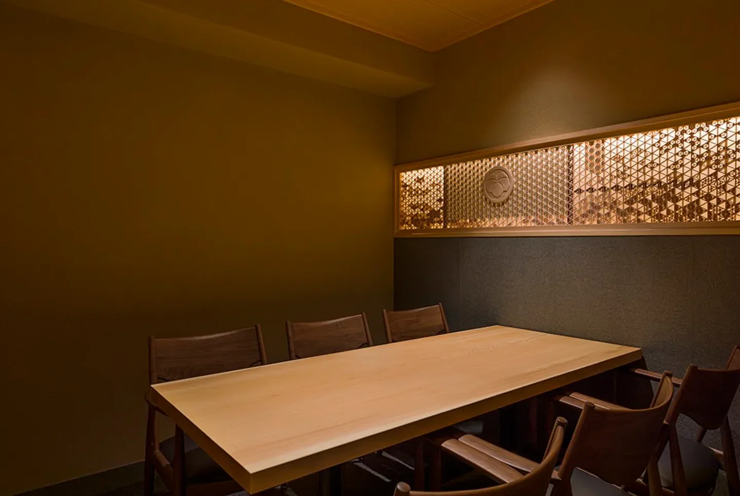 Interior dining space at Sushi Hashimoto in Tokyo, showcasing wooden table and chairs