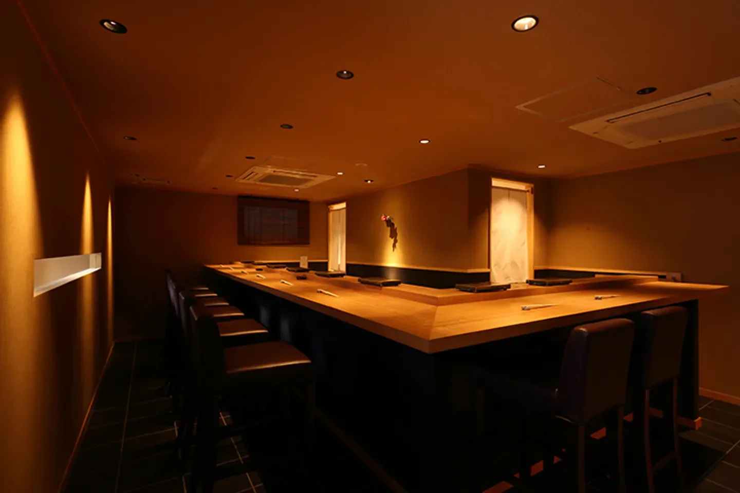 Interior of Sushi Hayashi in Kyoto, featuring a wooden counter and seating area.