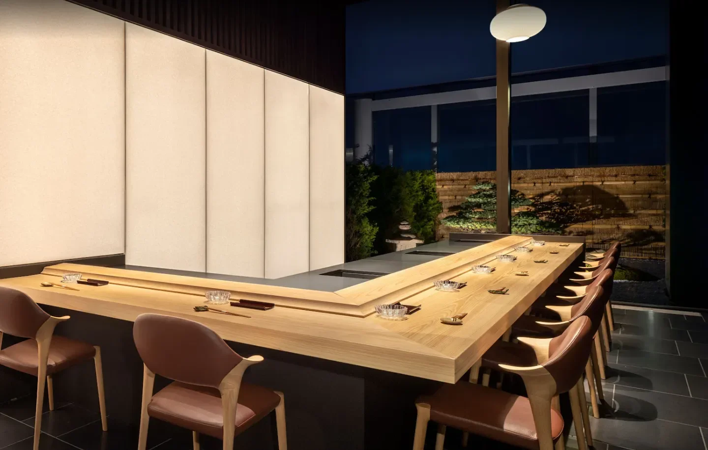 Interior of Sushi Hōseki in Tokyo, featuring a minimalist sushi counter and seating area.