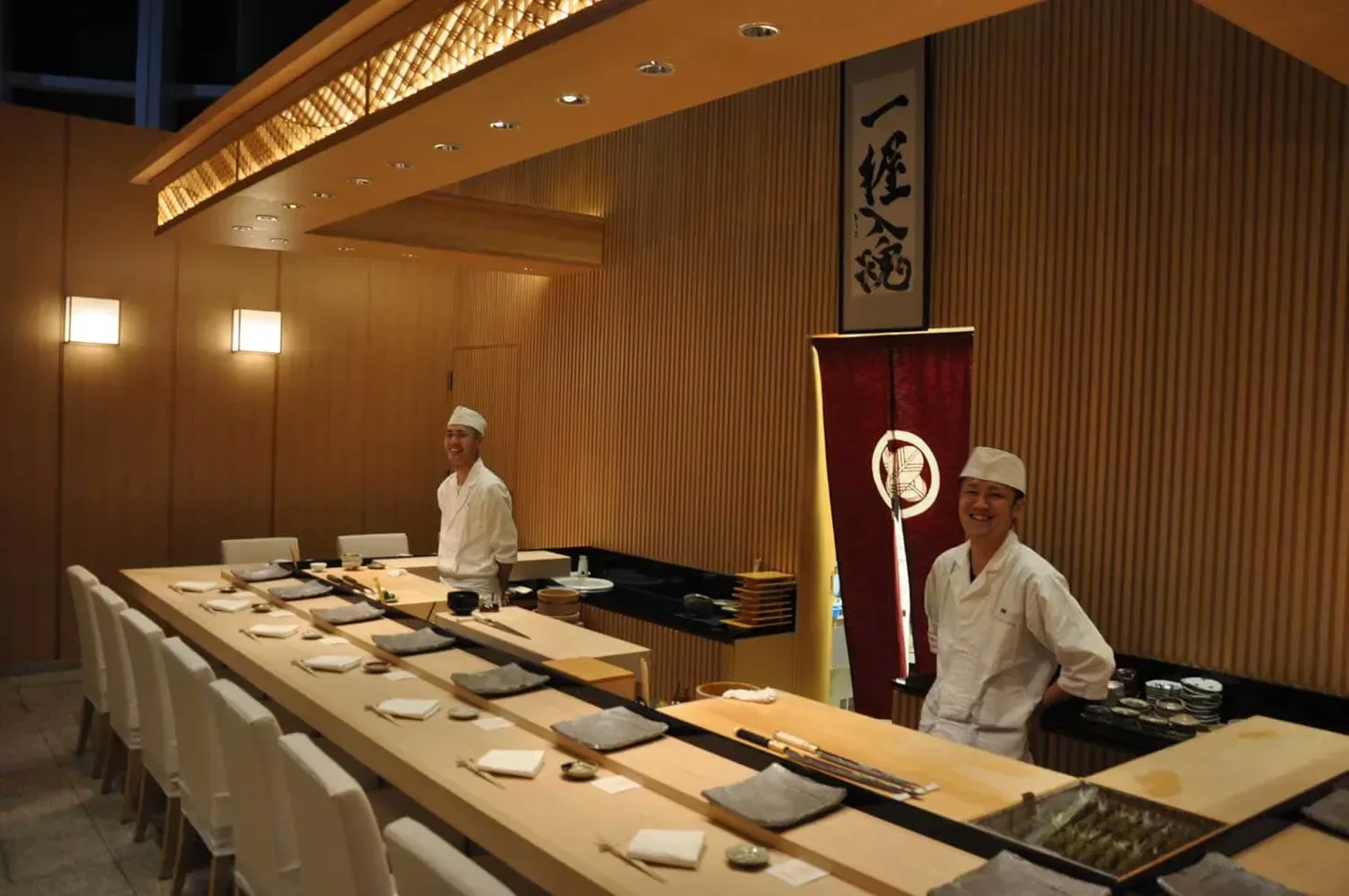 Interior of Sushi Kinetsu in Macau, showcasing sushi chefs and dining area.