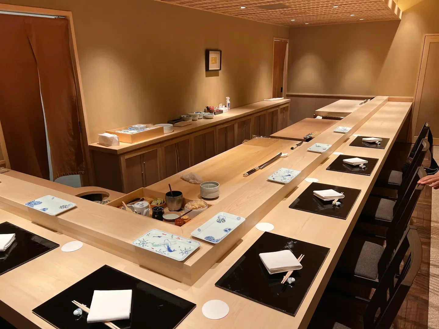 Interior of Sushi Kojima in Tokyo, sushi bar with elegant wood and minimalist design.
