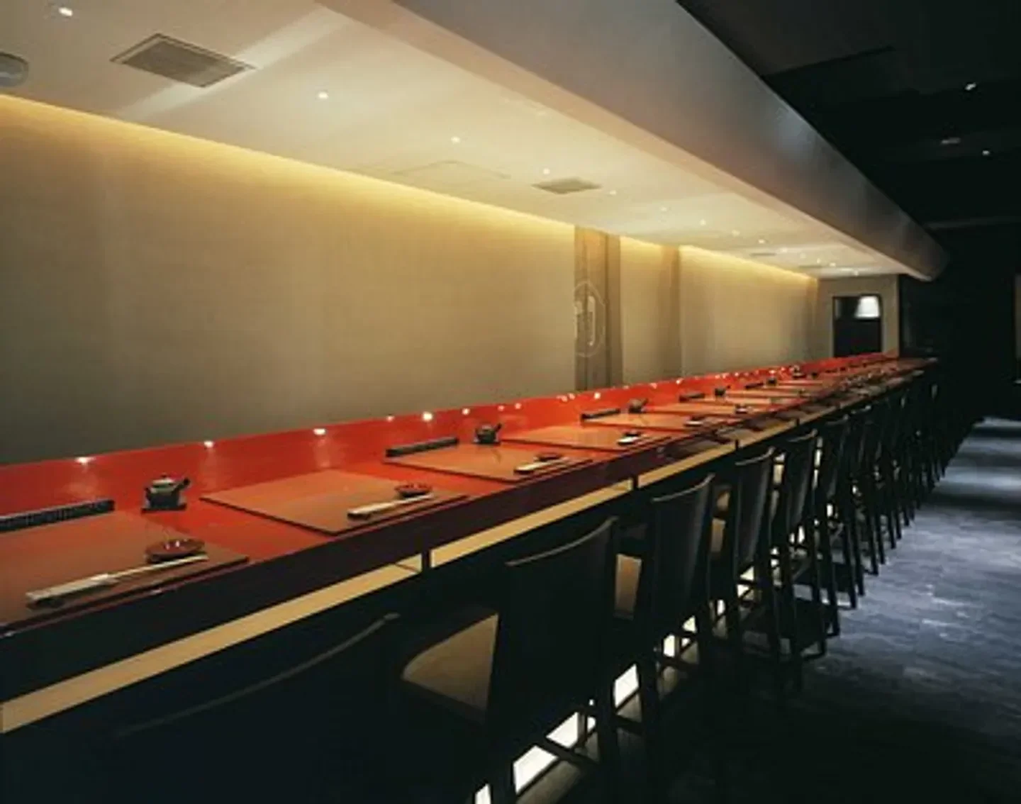 Interior view of Sushi Kuwano in Tokyo, showcasing elegant sushi bar and seating area.