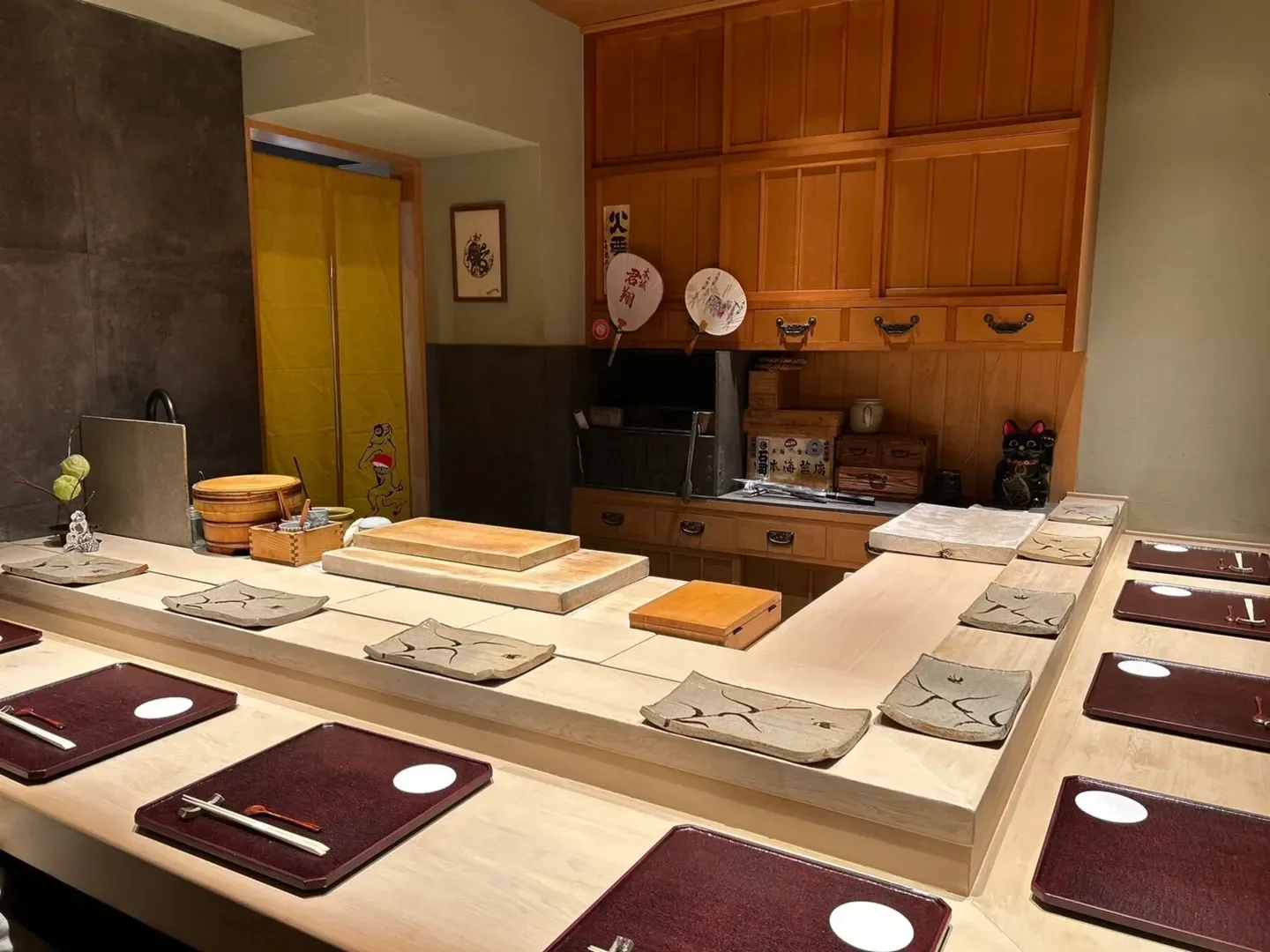 Interior of Sushi Murakami Jiro in Osaka, with sushi counter and traditional decor.