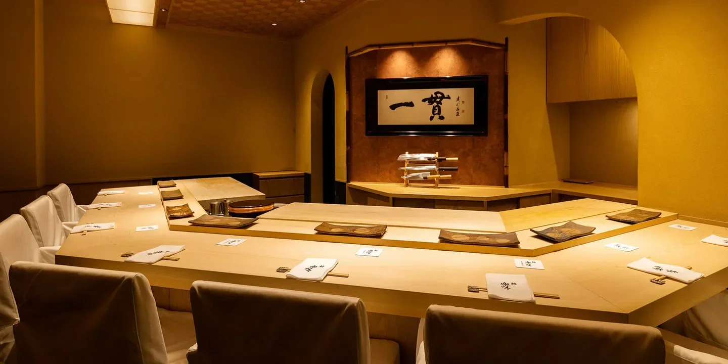 Interior of Sushi Rakumi in Kyoto, featuring a sushi bar and elegant dining space.