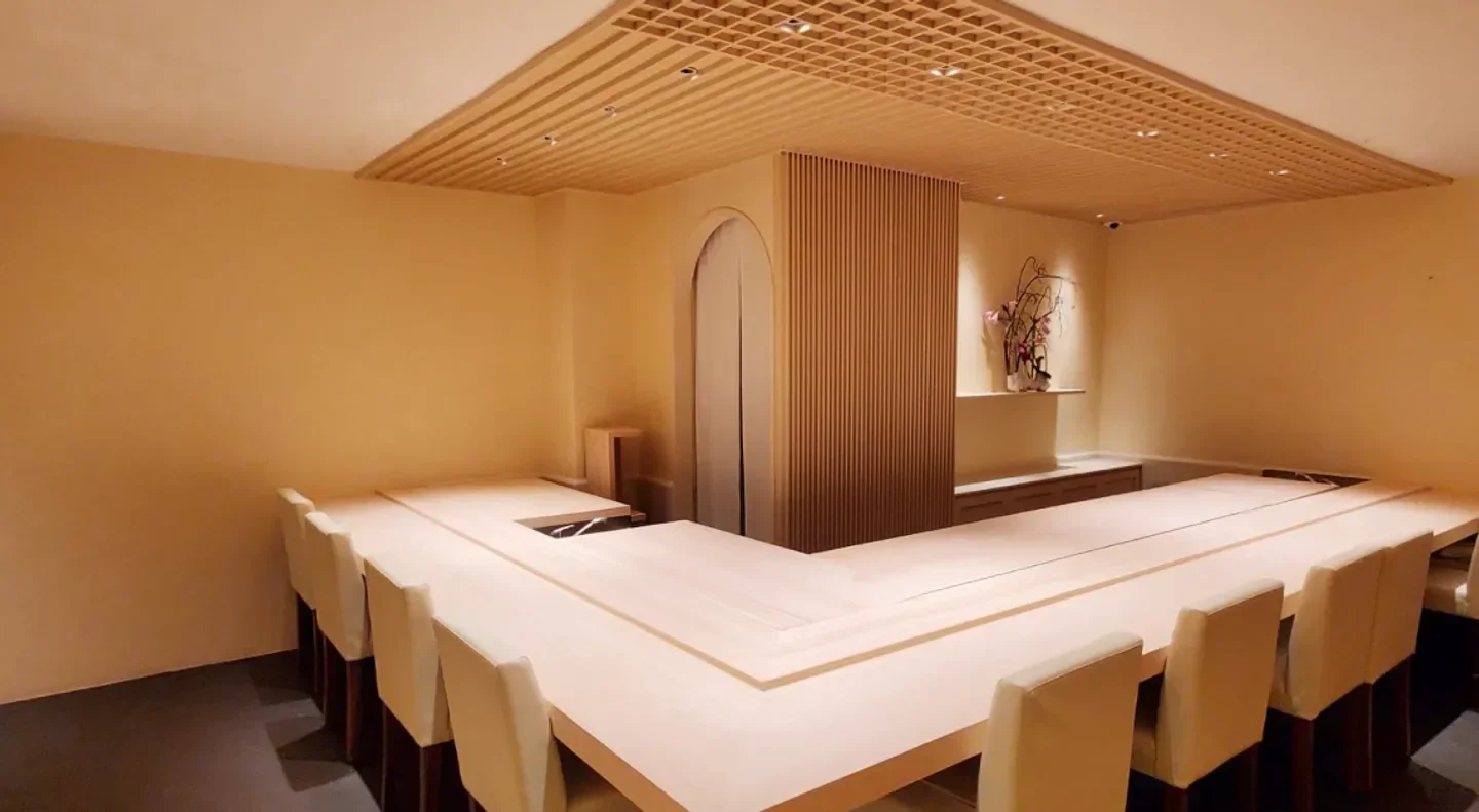 Interior view of Sushi Sakuta in Singapore, showing a minimalist dining space.