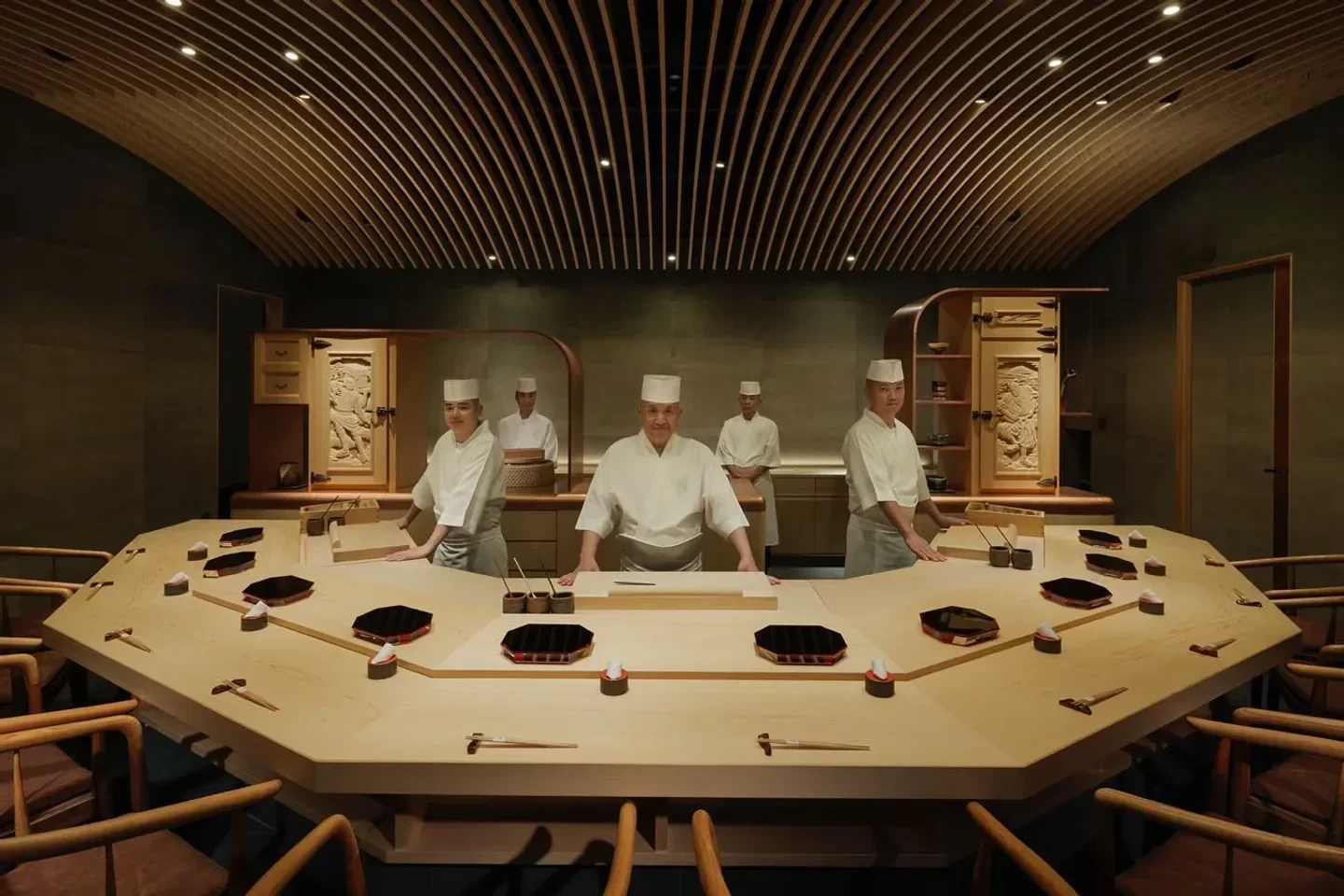 Chefs at Sushi Sho in Honolulu preparing sushi at the wooden counter.