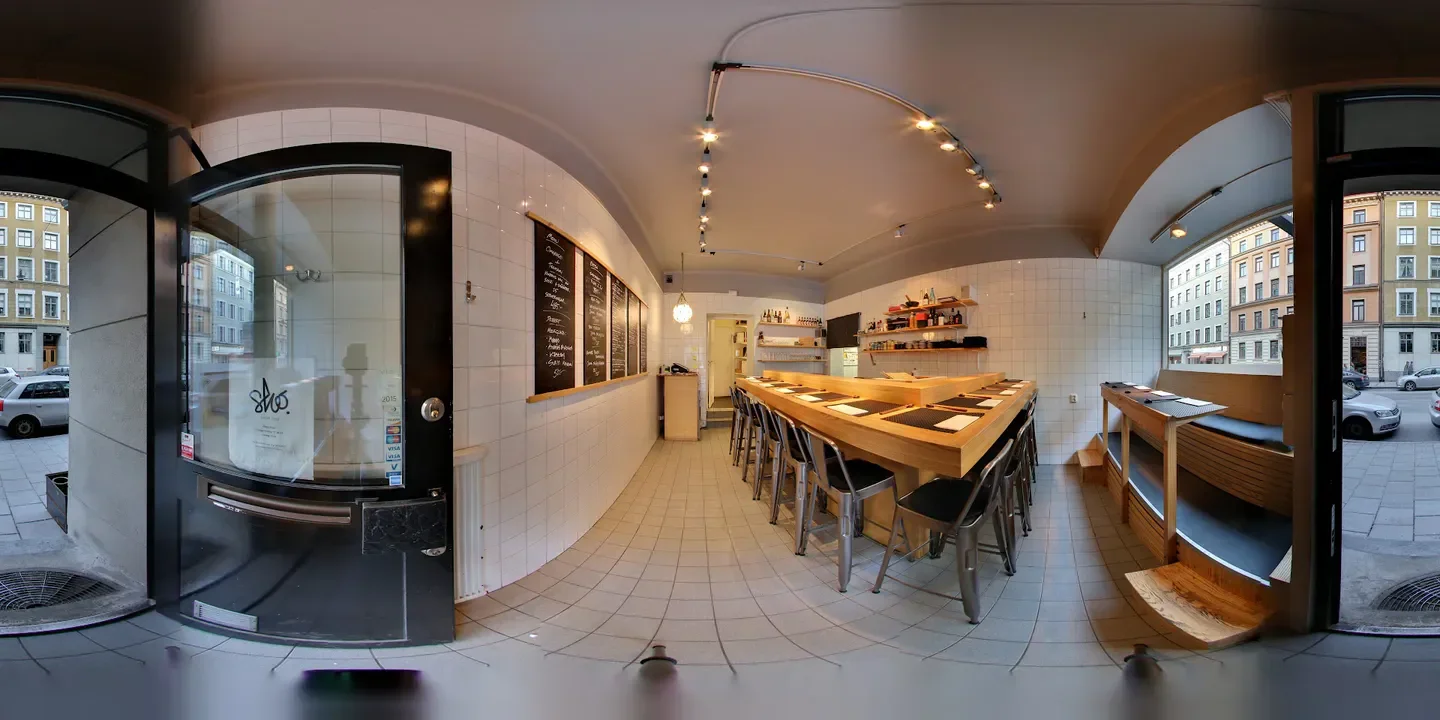 Interior view of Sushi Sho restaurant in Stockholm, featuring a sushi bar and seating area.