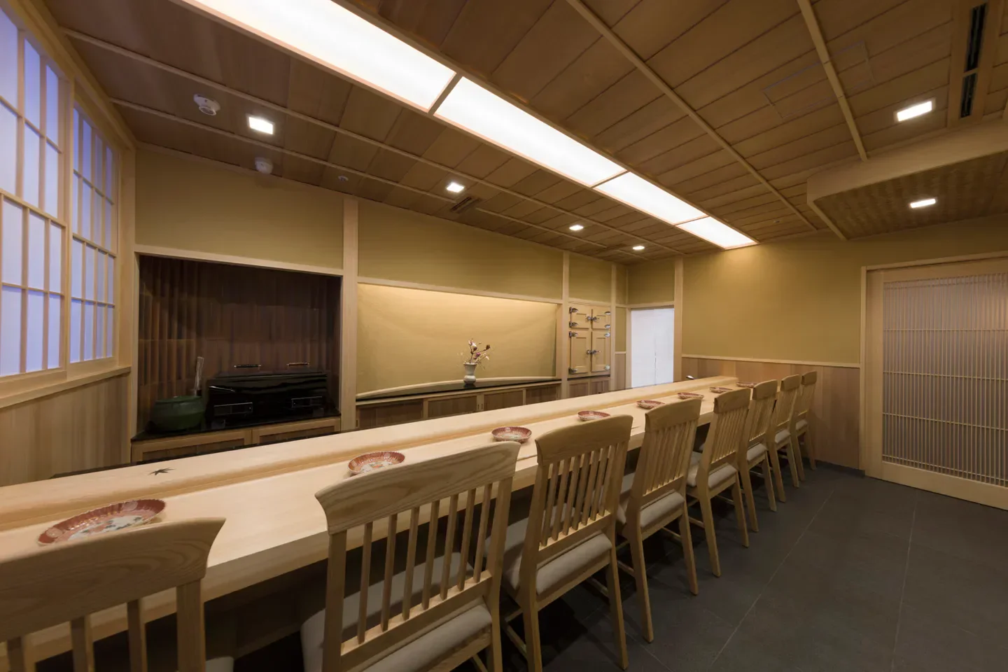 Interior of Sushi Yoshitake in Tokyo, featuring sushi bar and elegant Japanese design.