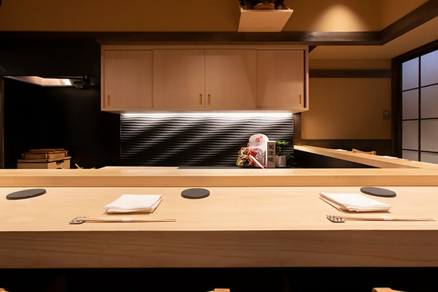 Interior view of Sushi Yuden restaurant in Osaka with wooden counter and decor