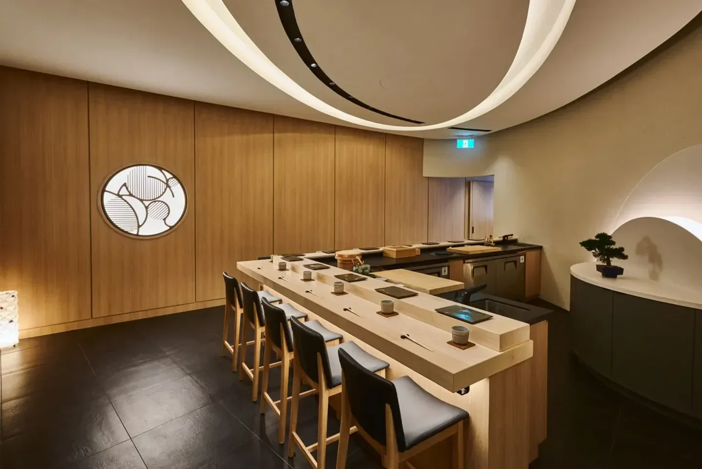 Interior of Sushi Yūgen in Toronto, with a view of the sushi counter and decor.