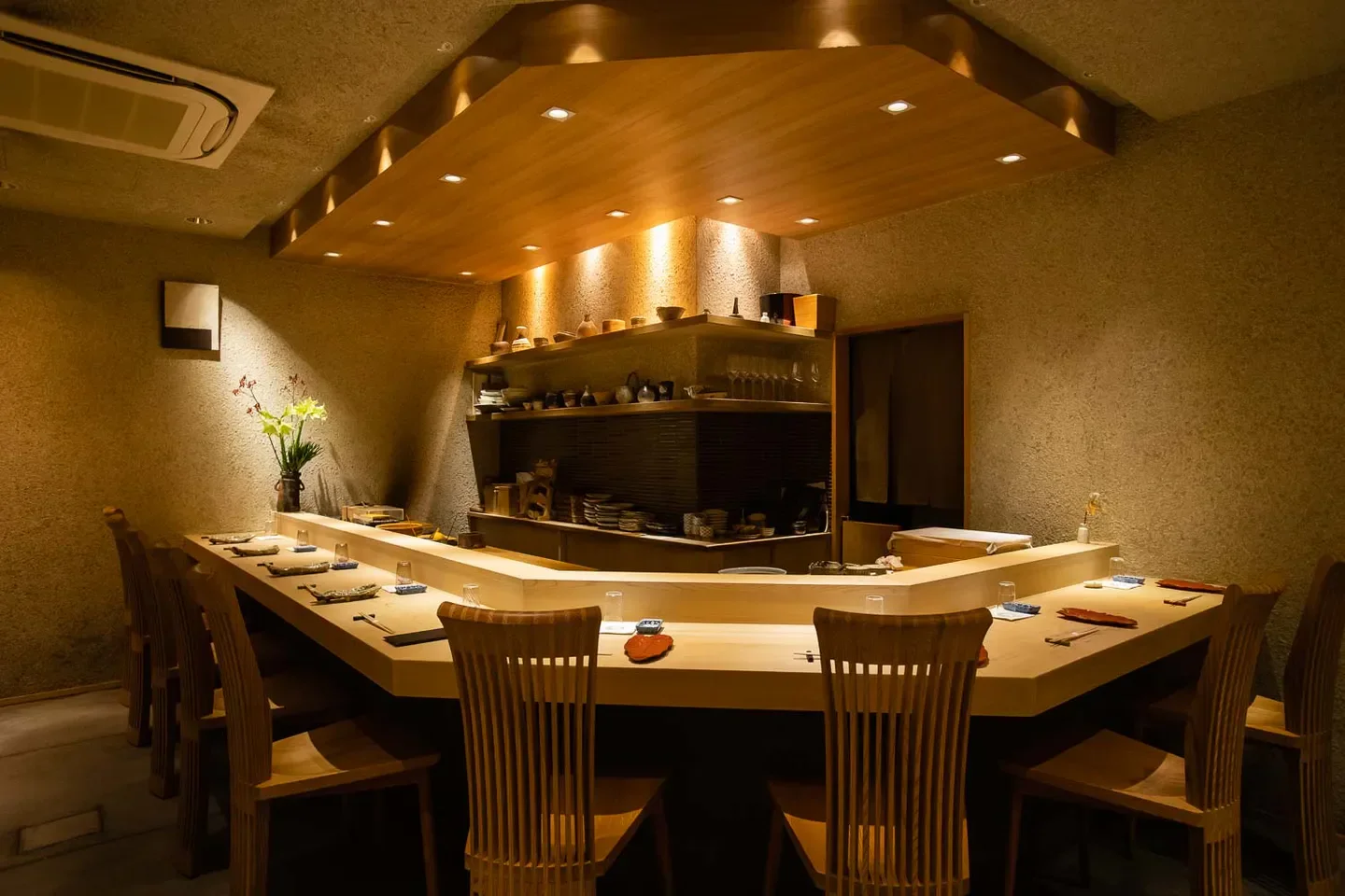 Interior of Sushidokoro Amano in Osaka, Japan, featuring sushi bar and seating.