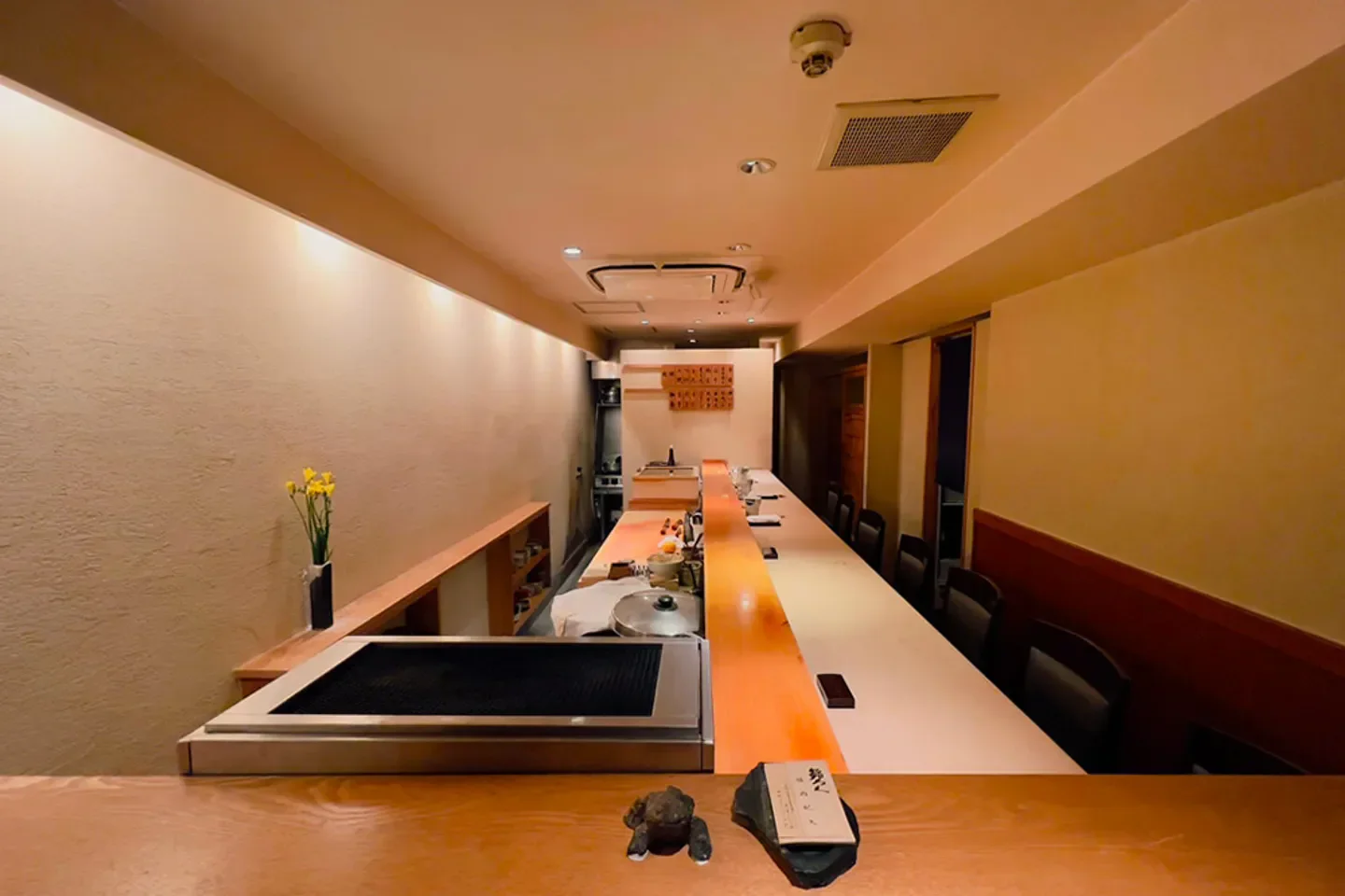 Sushiroku Osaka's sushi bar, showcasing a minimalist interior with a long, inviting counter